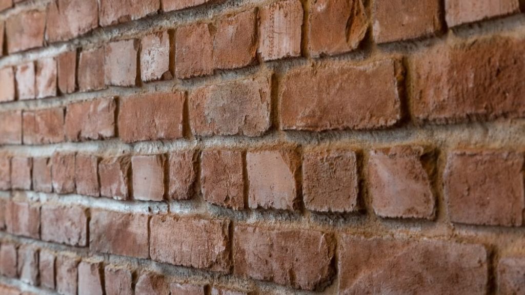 closeup burnt red brick wall apnel - muros