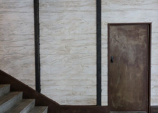 Wooden sleeper wall panels by Muros NZ can give the area around the staircase a great rustic look